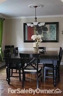 Dining Room : Crown molding on the ceilings and wainscoting in dining room, refinished floors
