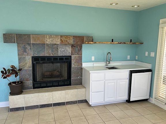 Little kitchen area with working fireplace.
