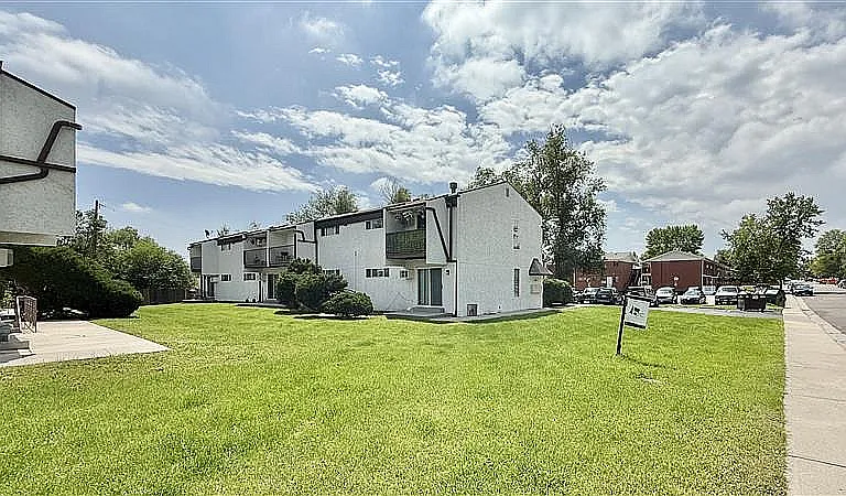 Charming apartment complex with modern architecture and lush green surroundings, perfect for comfortable living.