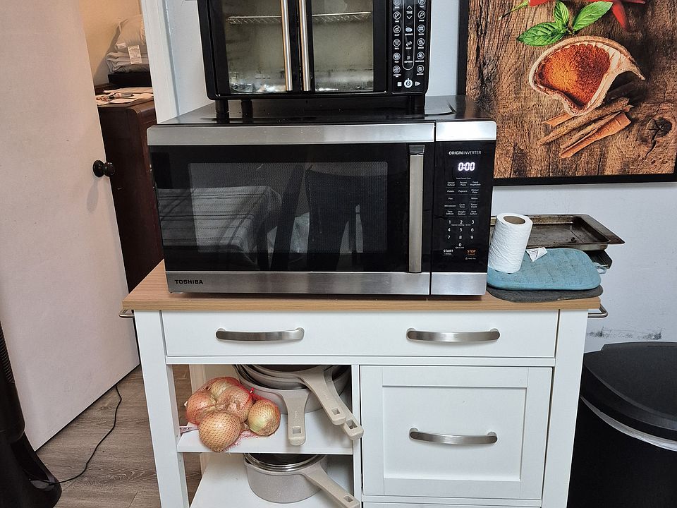 Toaster Oven, Microwave, additional storage unit, painting and trash can provided as shown.