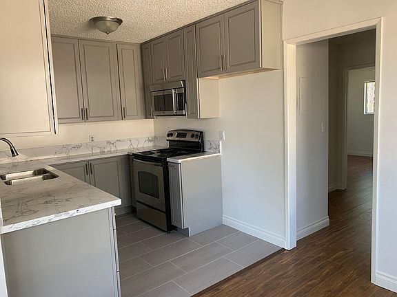 White refrigerator has been added to this kitchen