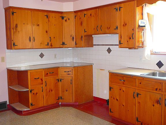 solid knotty pine kitchen cabinets and ceramic backsplash