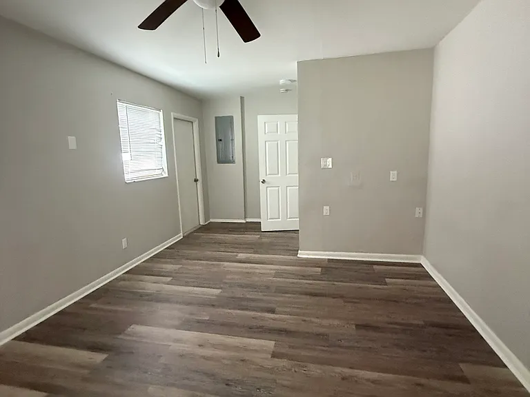 View from the closet/window in Master bedroom. The door next to the window leads out to the ac unit, gated back yard, and pathway to the front.