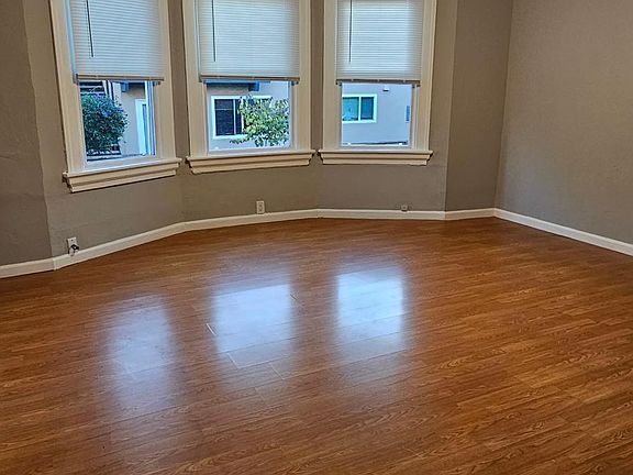 Natural light/fresh air ushered in via these three windows in the living room.