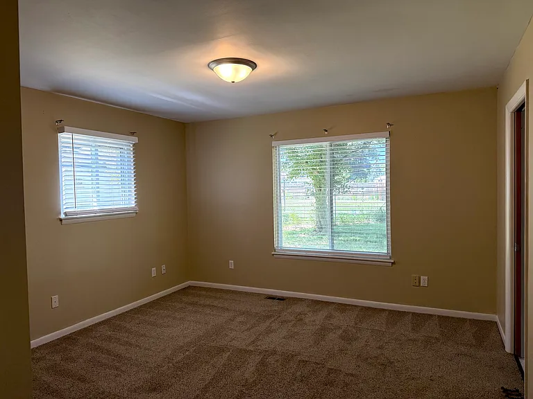 6310-Master Bedroom, View from hallway, left window overlooks side yard, larger window on right overlooks backyard, Master Bath is on the right
