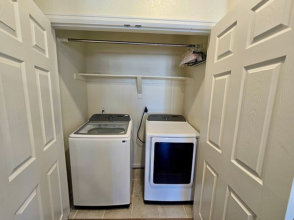 In unit washer and dryer, with a clothing rack for hang dry needs.