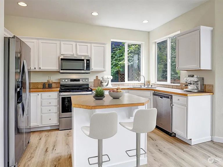 Kitchen area with large windows and backyard view