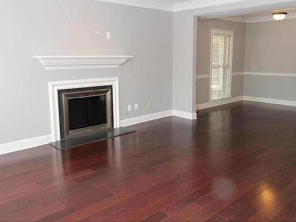 Living room with gas starter fireplace, open to Dining area.