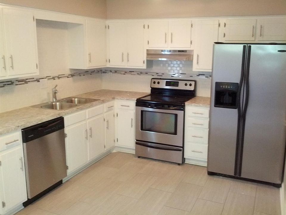 Updated kitchen with range, dishwasher, side by side refrigerator.