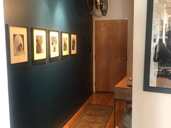 Coat closet to the right and pulley bike storage