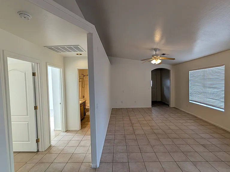 This bright family room serves as the heart of the home, with a separate hallway leading to the well-appointed guest bedrooms and a shared guest bathroom.