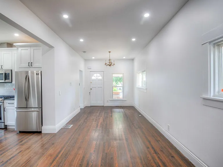 Living room and dining room with view of kitchen and front door.