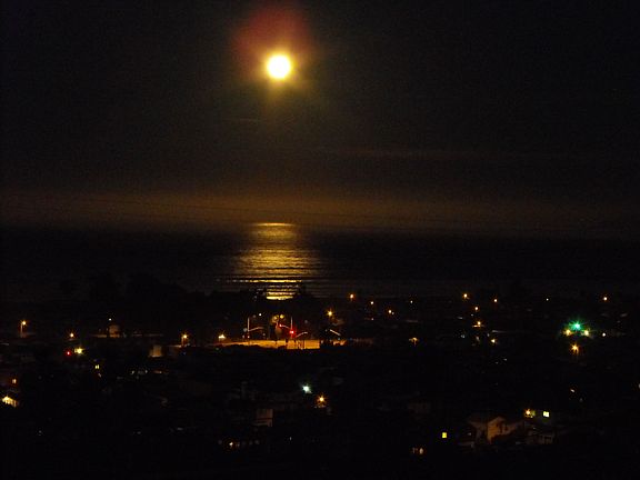 Moon setting over ocean