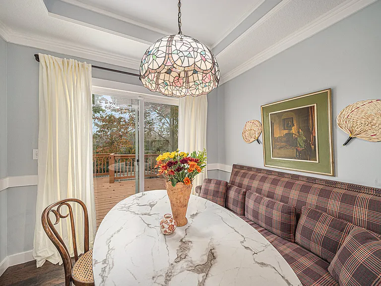 Enjoy meals with a view in this cozy dining area, featuring natural light from the sliding balcony doors that bring the outdoors in.