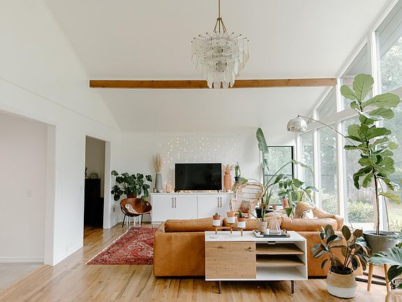 Huge and beautiful living room with salted ceilings and with backyard views and tons of natural light. Faces South. Built in tv stand that looks like a piece furniture. Comes with the house.