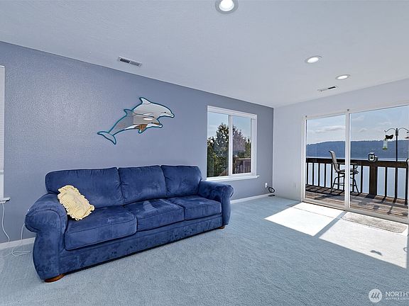 Sunny living room just off of the kitchen, with a slider to the deck.>