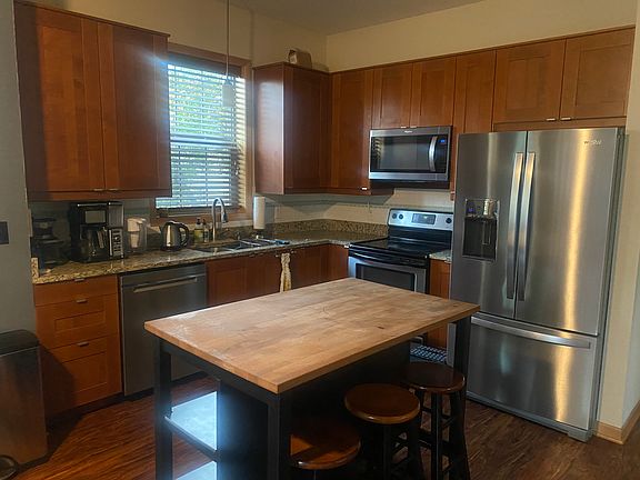 kitchen with new stainless fridge and dishwasher