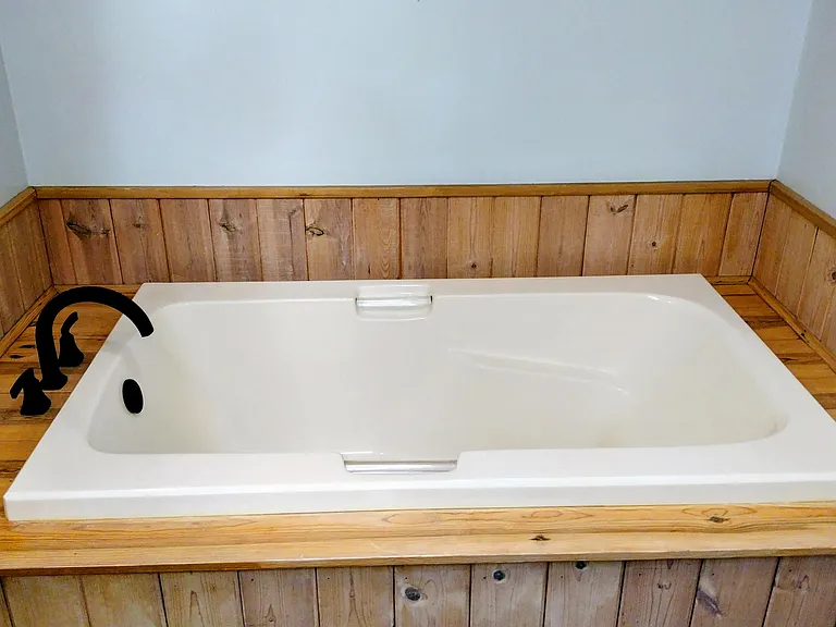 Second full bathroom has a soaker tub for relaxing after a day skipping rocks at the local beaches.