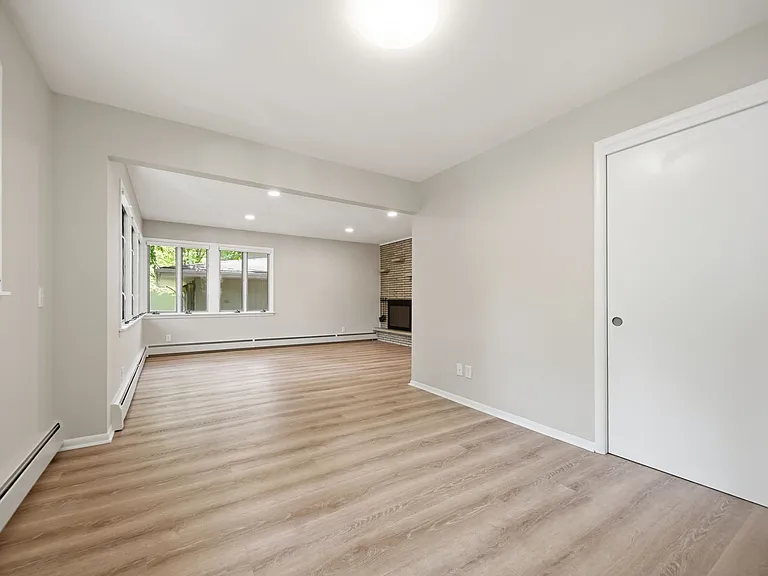 View of open study, closet, and living room (in distance)