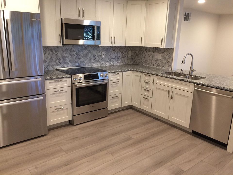 Full kitchen with granite countertops, marble backsplash, & all new Bosch appliances, including dishwasher.