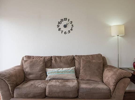 Minimalist clock resides over the couch