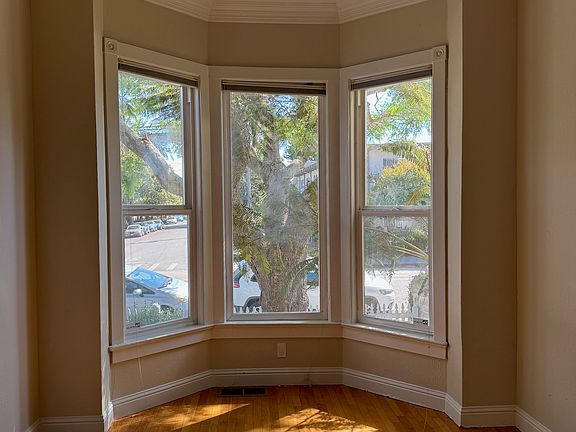 Bright Living room bay window with hardwood floors.