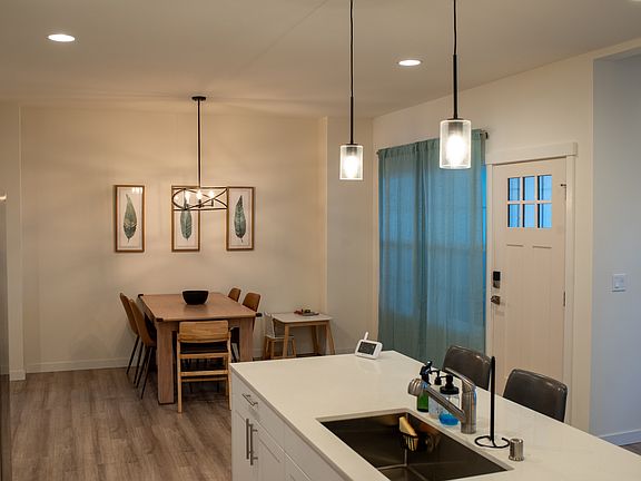 Kitchen & Dining room. Note the large window and craftsman style door leading out to the back covered deck and fenced in back yard.