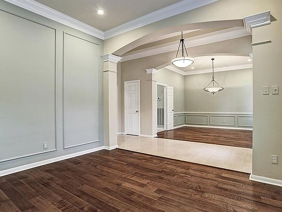A view of the formal dining room and the formal living room. Beauitful floors!