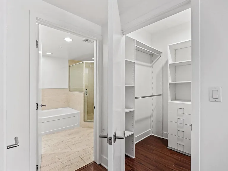 Walk-In Closet and Bathroom with a Full-Size Bathtub and a Walk-In Shower