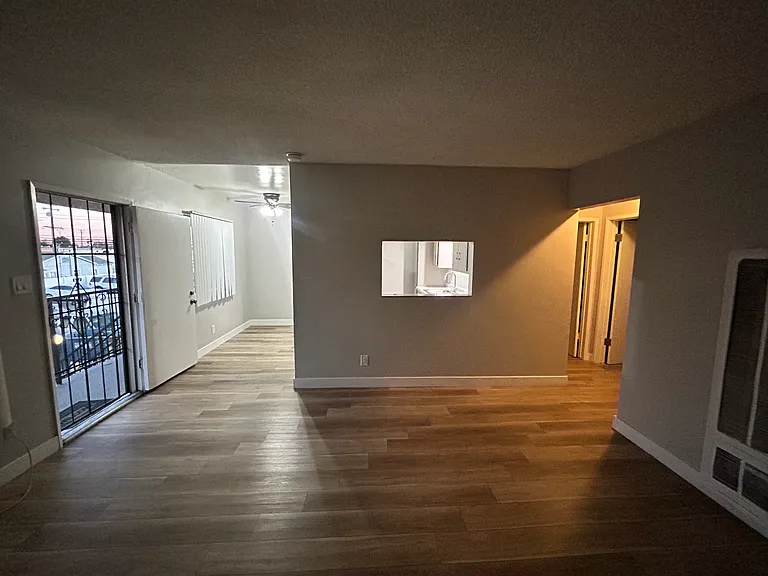Alternate view of living room wiith eat-in kitchen next to it