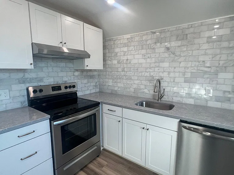 Quartz counters, marble backsplash.