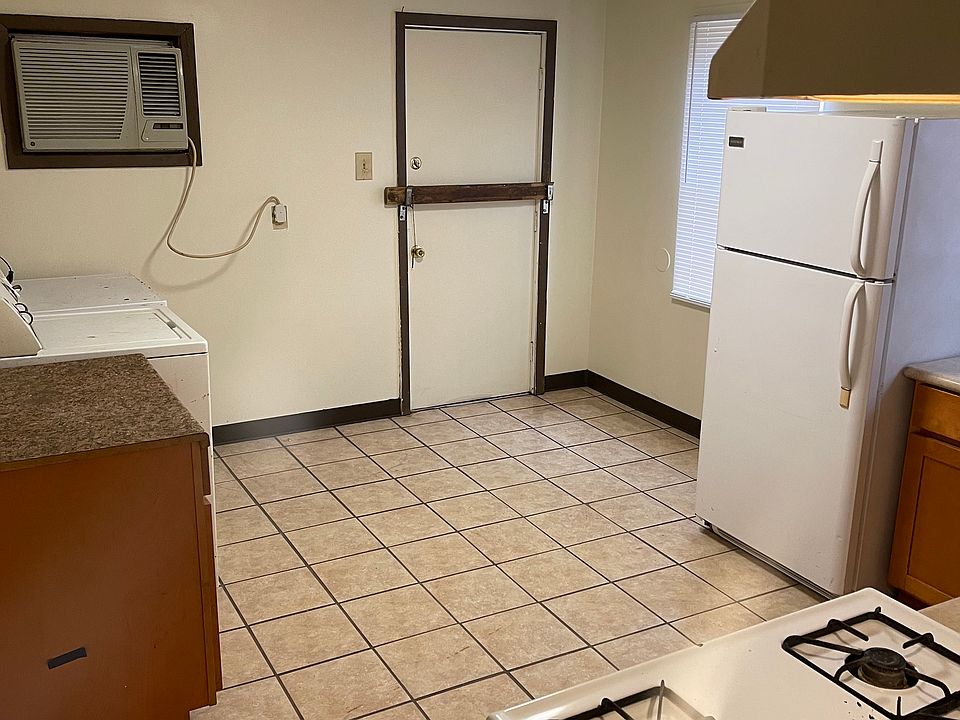 Back door to the yard, complete with washer and dryer units.