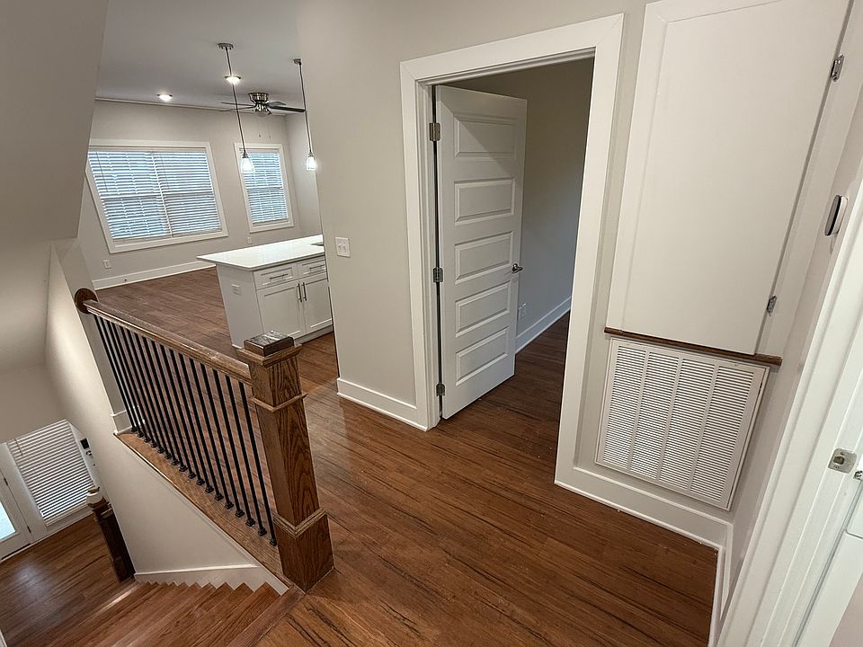 Second-Floor Landing: Bright, open, connecting the living area, full bathroom, and private bedroom.