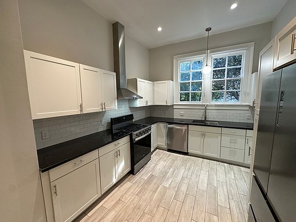 Fully renovated kitchen with granite countertops and all-new stainless steel appliances