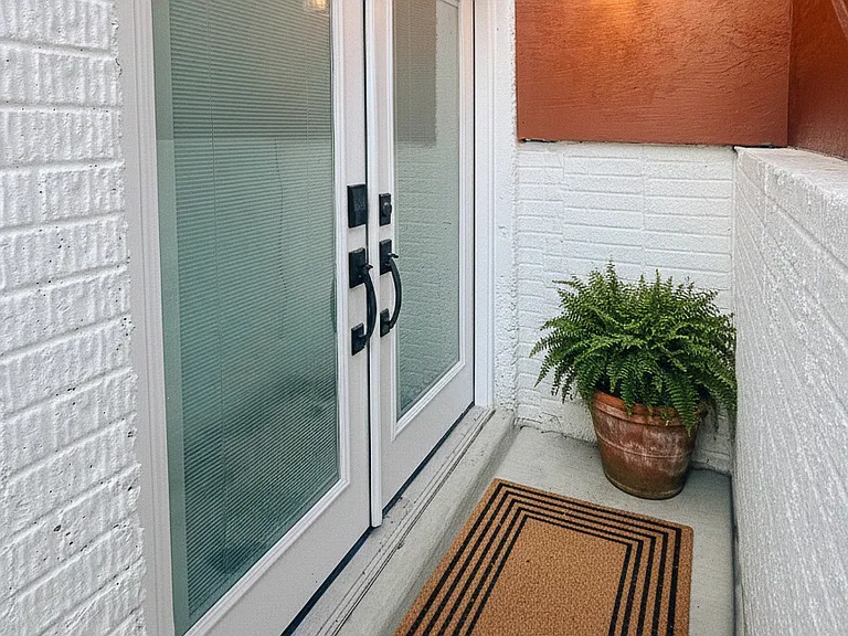 Exterior stairway and private entrance area leading down to the apartment.