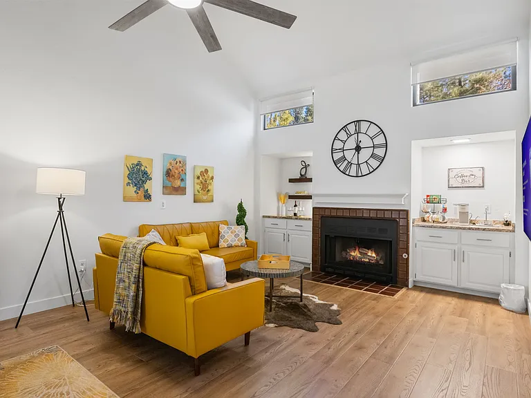 The living room features a spacious design with a cozy gas fireplace.
