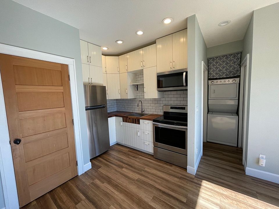 Newly updated kitchen, pantry door, and washer/dryer