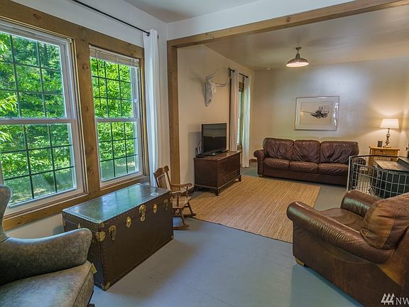 Pine millwork complements the fresh white walls and freshly painted fir floors in the entry/living room.