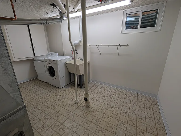 Large laundry room with utility sink