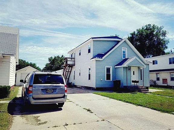 Front of the house. Railing to the left side leads up to upstairs unit which is rented out to another family. Completely closed off from the rest of the home that you would be living in.