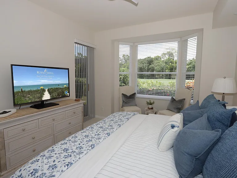 Master Bedroom overlooks the golf course and features a king-size bed, TV, two walk-in closets, a sitting area, and an ensuite bathroom