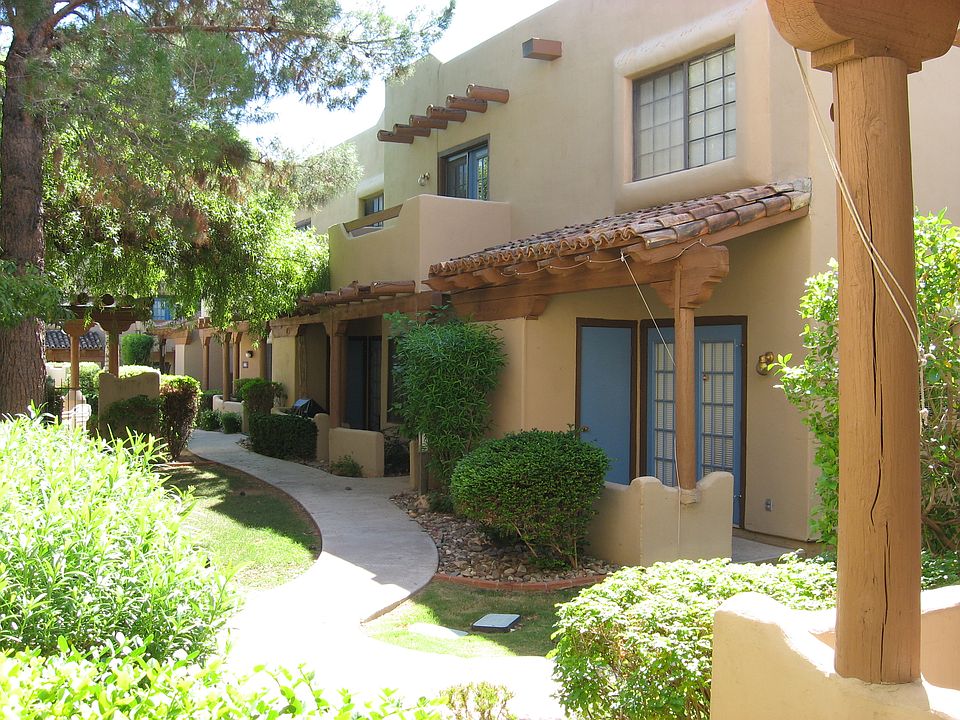 Charming and lush paths through the adobe style townhomes, corner unit, with patio and balcony.