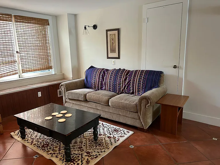 Furniture includes comfortable couch that sits three, coffee table, side table