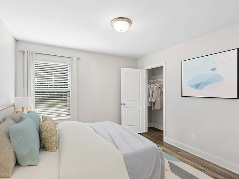 Secondary bedroom with queen size bed and large window letting in a ton of natural light.