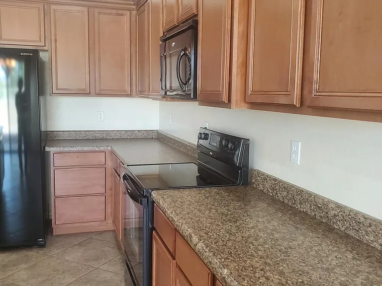 KITCHEN, TONS OF CHERRY CABINETS, LOTS OF COUNTERSPACE.