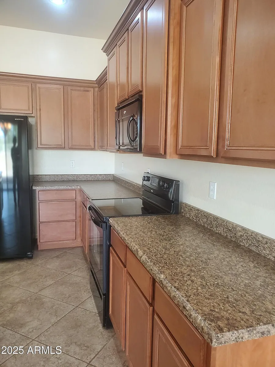 KITCHEN, TONS OF CHERRY CABINETS, LOTS OF COUNTERSPACE. - 18188 W Paradise Ln