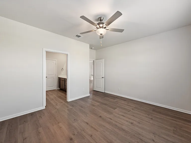 The master suite has a large bedroom, ensuite bathroom and a walk-in closet.