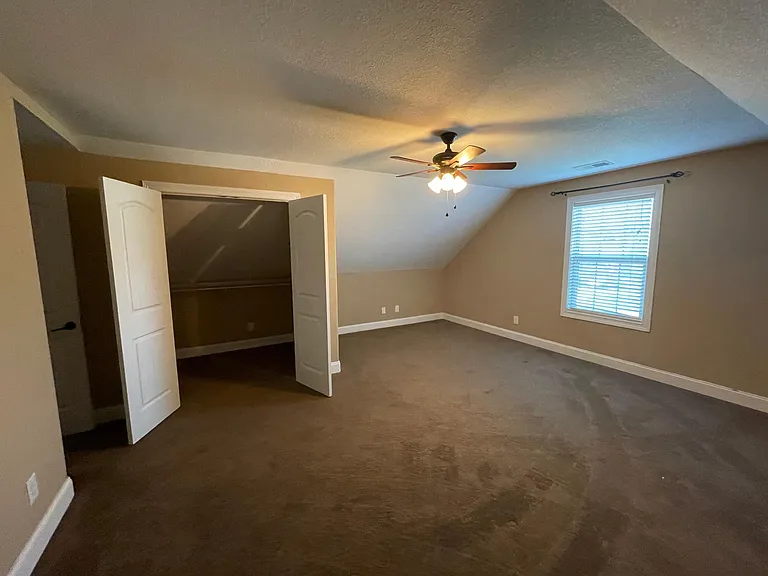 Expansive upstairs bedroom with large walk in closet for plenty of storage.