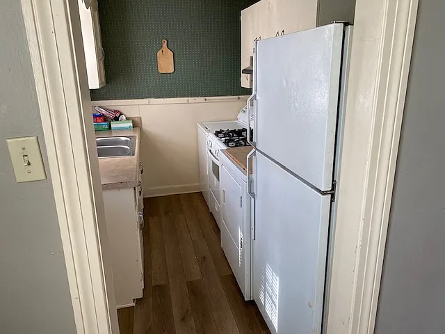 Kitchen with Stove, Washer, Dyer and Refrigerator.