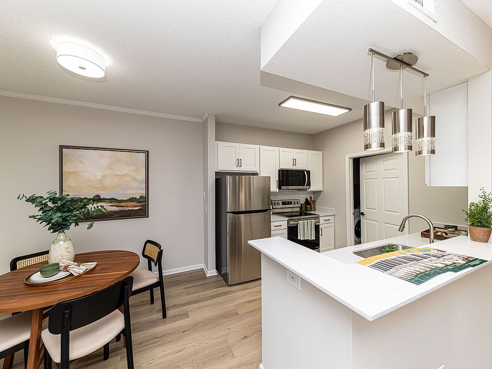 Kitchen with quartz couters, modern cabinetry, & hardwood-style flooring